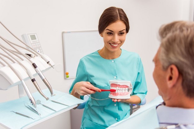 patient receiving dentures from dentist